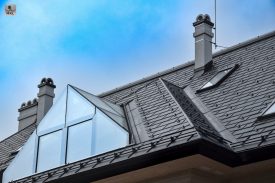 Kúria-Nová-dedina-00moderný dom s kamenným obkladom, dreveným šindľovým opláštením a sivou falcovanou strechou MKL, presná geometria, slnečné svetlo